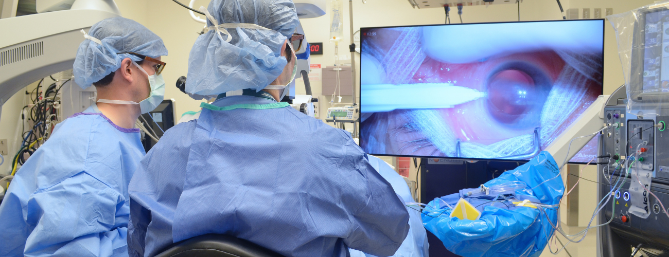 Eye doctors operating on a patient using an ngenuity camera 